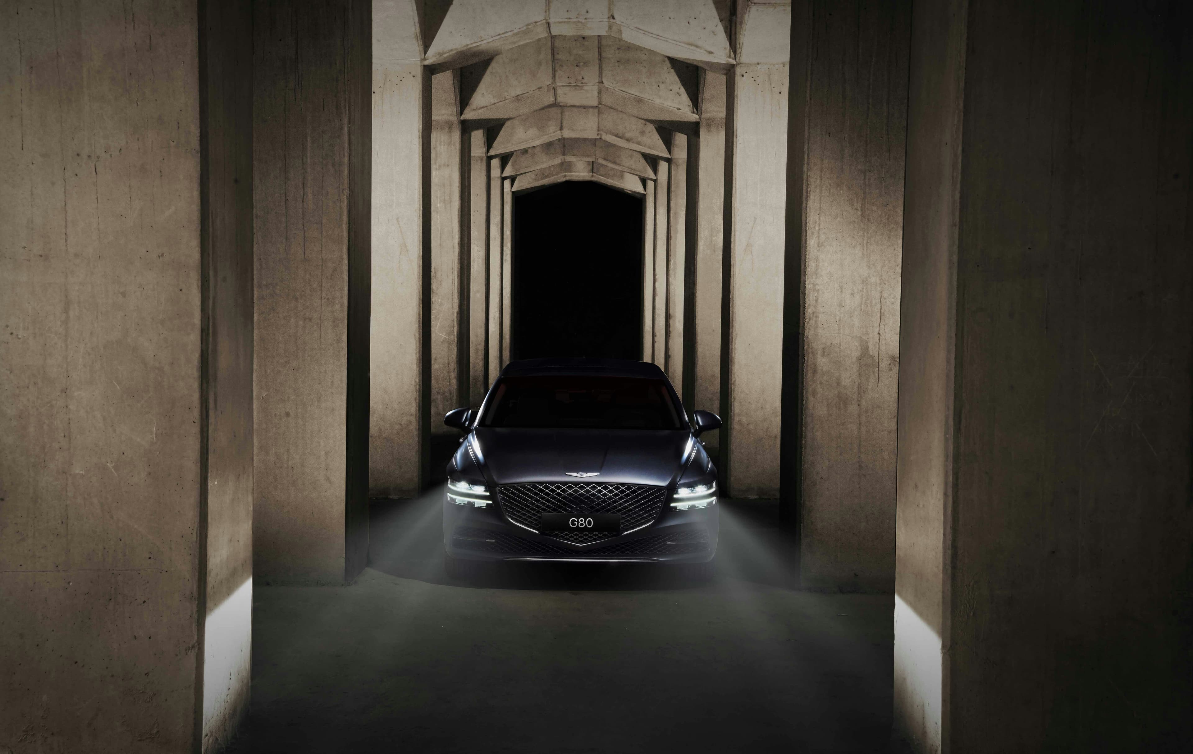 A vehicle approaching through a columned archway